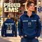 EMS Proud Walk Vintage Hoodie in Dark Blue, front right back card composition with faithful front and back artwork in a calm station entrance with a parked ambulance softly out of focus.