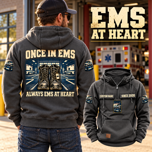 EMS Once and Always Vintage Hoodie in Dark Gray, back left front cutout composition with faithful front and back artwork in a calm station entrance with a parked ambulance softly out of focus.