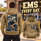 EMS Ready Every Day Portrait Vintage Hoodie in Kaki, back left front cutout composition with faithful front and back artwork in a calm station entrance with a parked ambulance softly out of focus.