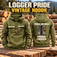 Logger Proud Walk Vintage Hoodie in Military Green, paired front back composition with faithful front and back artwork in a timber yard with stacked logs softly out of focus.
