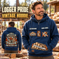 Logger Heritage Crest Vintage Hoodie in Dark Blue, front right back card composition with faithful front and back artwork in a timber yard with stacked logs softly out of focus.