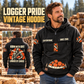 Logger By Choice Vintage Hoodie in Black, front right back card composition with faithful front and back artwork in a timber yard with stacked logs softly out of focus.