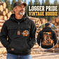 Logger Ready Every Day Portrait Vintage Hoodie in Black, front left back inset composition with faithful front and back artwork in a timber yard with stacked logs softly out of focus.