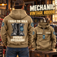 Mechanic Proud Walk Vintage Hoodie in Kaki, back left front cutout composition with faithful front and back artwork in a tidy auto workshop with a vintage vehicle blurred behind.