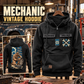 Mechanic Workday Portrait Vintage Hoodie in Black, front right back card composition with faithful front and back artwork in a tidy auto workshop with a vintage vehicle blurred behind.