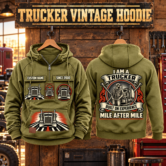 Trucker Heritage Crest Vintage Hoodie in Military Green, paired front back composition with faithful front and back artwork in a quiet roadside truck stop with a parked tractor cab blurred behind.