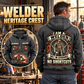 Welder Heritage Crest Vintage Hoodie in Dark Gray, back right front inset composition with faithful front and back artwork in a tidy welding workshop, no active welding or sparks.