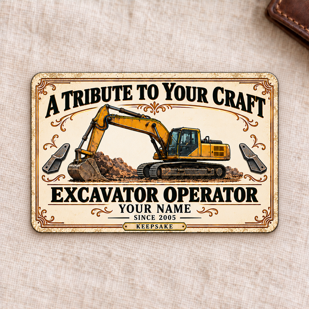 Front of the Ivory Heritage Tribute Excavator Operator aluminum wallet card on cream linen.