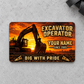 Front of the Sunset Workday Excavator Operator aluminum wallet card on a light gray concrete surface.