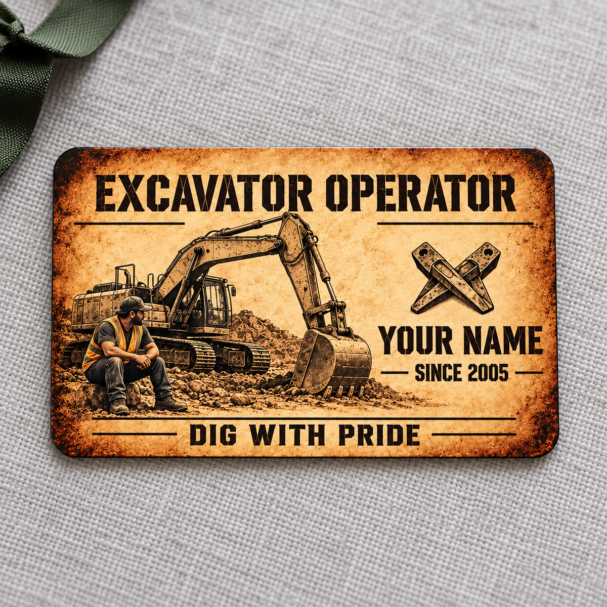 Front of the Sepia Craft Legacy Excavator Operator aluminum wallet card on light gray fabric.