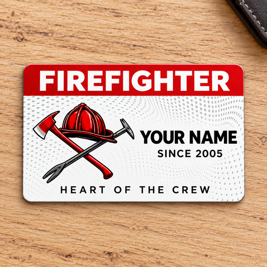 Front of red-header Firefighter aluminum wallet card with helmet and crossed tools on pale oak.