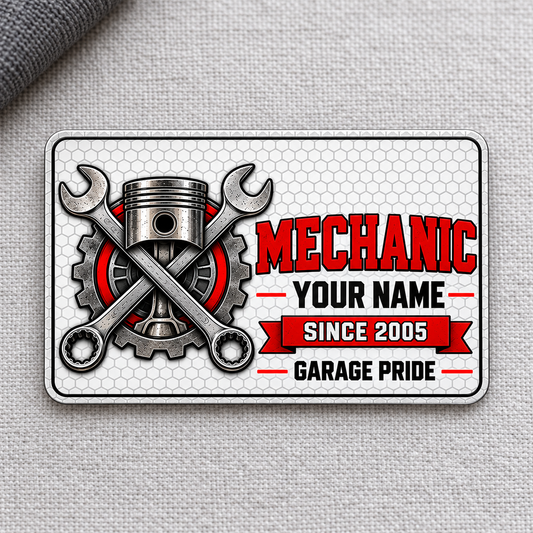 Front of Mechanic Honeycomb Pride aluminum wallet card on light gray woven fabric.
