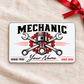 Front of Mechanic Signature Classic aluminum wallet card on cream linen with red gift ribbon.
