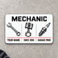 Front of Mechanic Minimal Tool Grid aluminum wallet card on pale gray concrete.