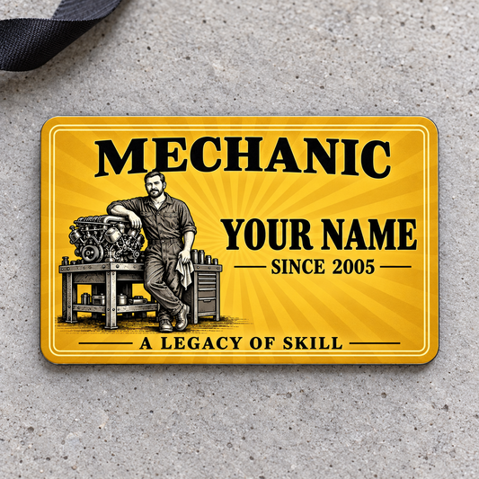 Front of Mechanic Golden Milestone aluminum wallet card on pale gray concrete.