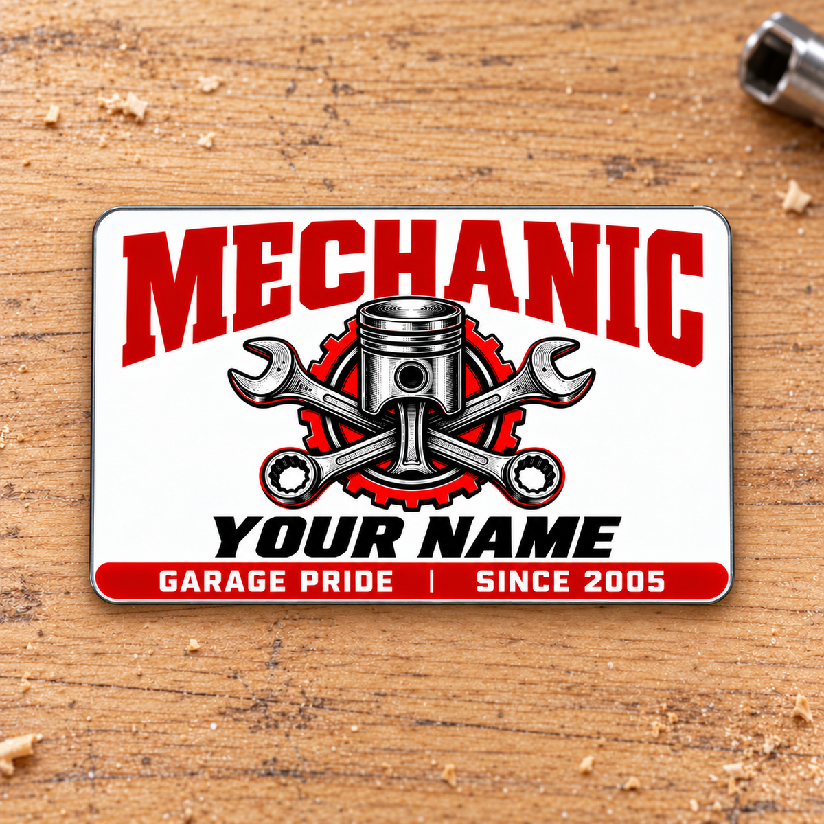 Front of Mechanic Signature Modern aluminum wallet card on pale oak.