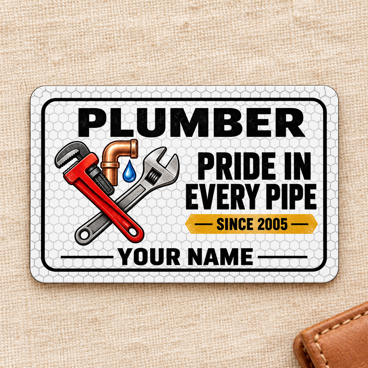 Plumber Honeycomb Pride aluminum wallet card, front design on cream linen.