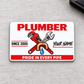 Plumber Signature Classic aluminum wallet card, front design on soft gray fabric.
