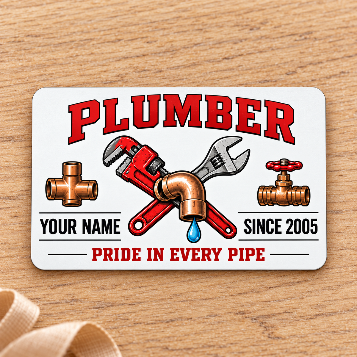 Plumber Minimal Tool Grid aluminum wallet card, front design on pale oak.