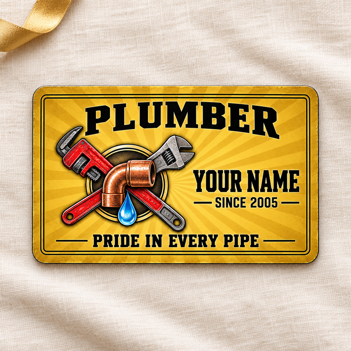 Plumber Golden Milestone aluminum wallet card, front design on cream linen.