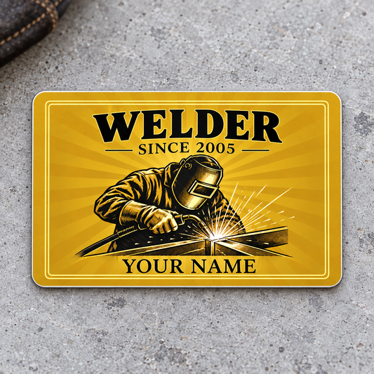 Welder Golden Milestone aluminum wallet card front on gray concrete