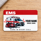 EMS Red Header aluminum wallet card, single front with ambulance and response tools on pale oak.
