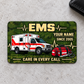 EMS Rugged Field aluminum wallet card, single front with olive camouflage and ambulance artwork on light gray concrete.