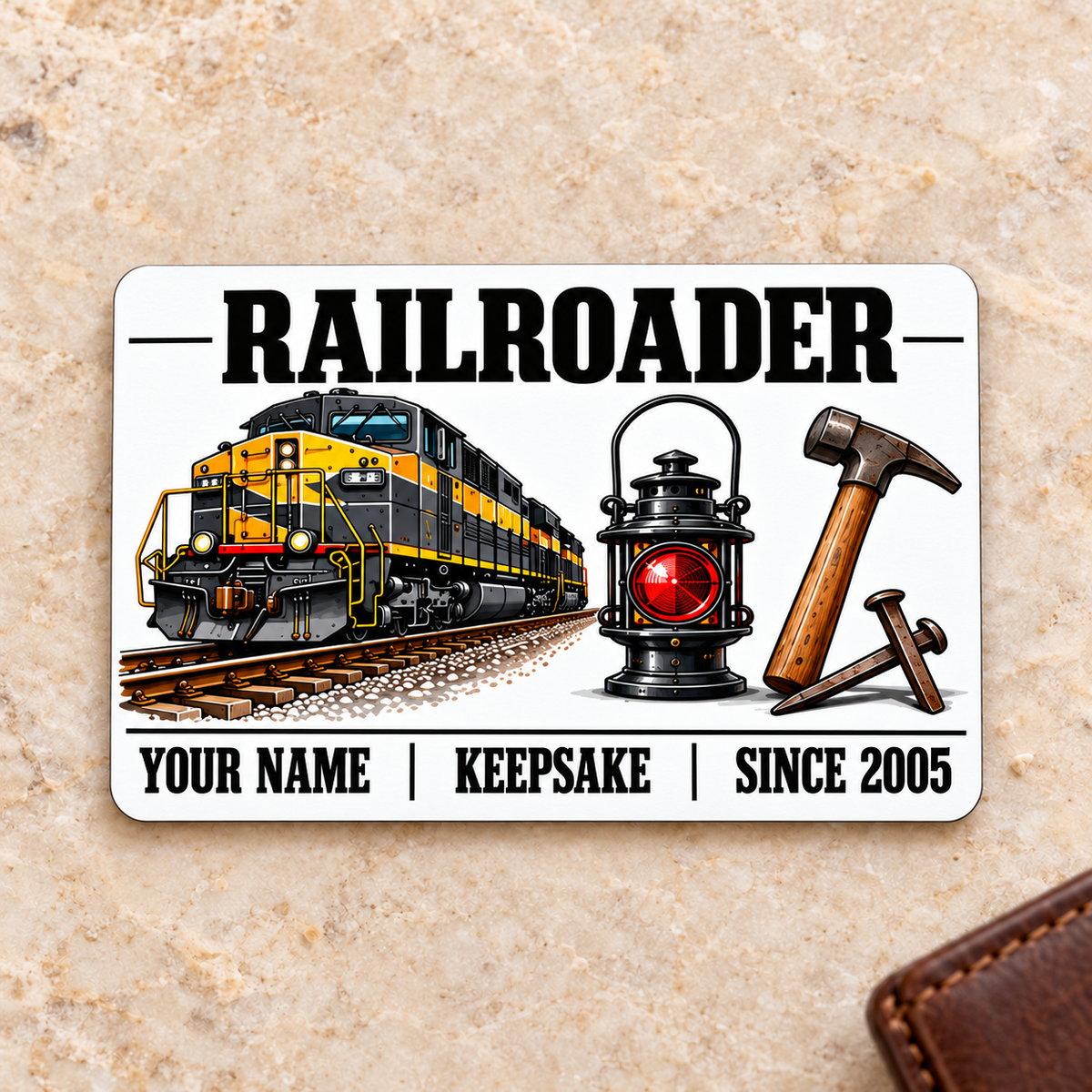 Railroader Minimal Tool Grid aluminum wallet card, front face on cream stone beside a brown wallet.