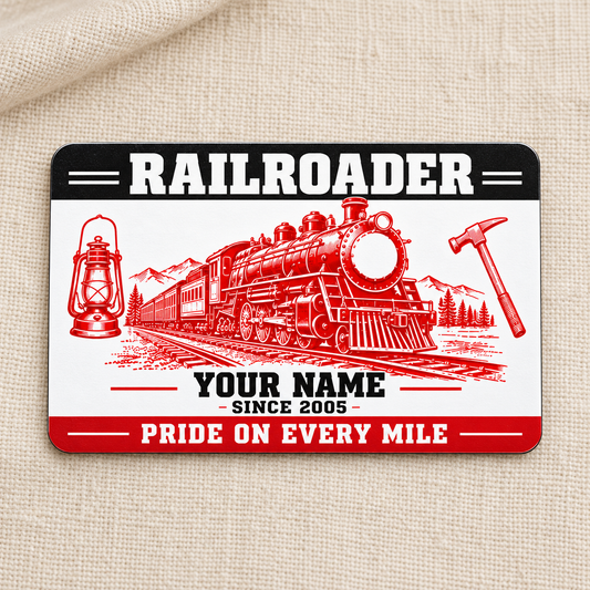 Railroader Red Monochrome aluminum wallet card front on cream linen, showing red locomotive, lantern and track hammer artwork.
