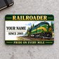 Railroader Heritage Band aluminum wallet card front on gray concrete, with green-and-gold locomotive artwork.