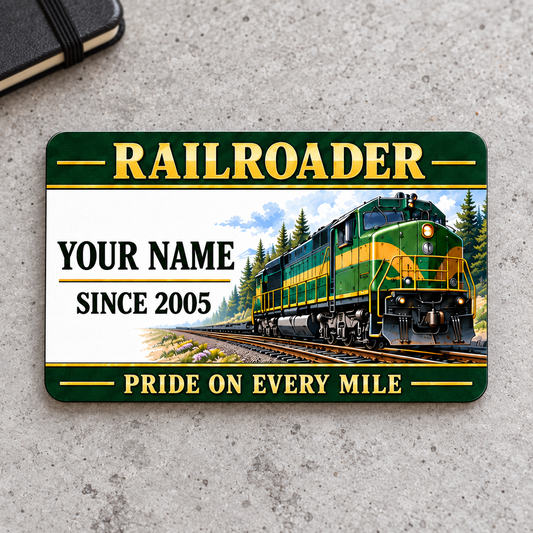 Railroader Heritage Band aluminum wallet card front on gray concrete, with green-and-gold locomotive artwork.