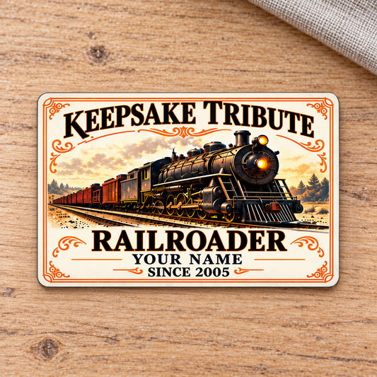 Railroader Ivory Heritage aluminum wallet card front on pale oak, with a steam locomotive and ornate ivory-and-gold design.
