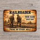 Railroader Sepia Legacy aluminum wallet card front on pale gray wood, showing two rail workers with a lantern and track hammer.
