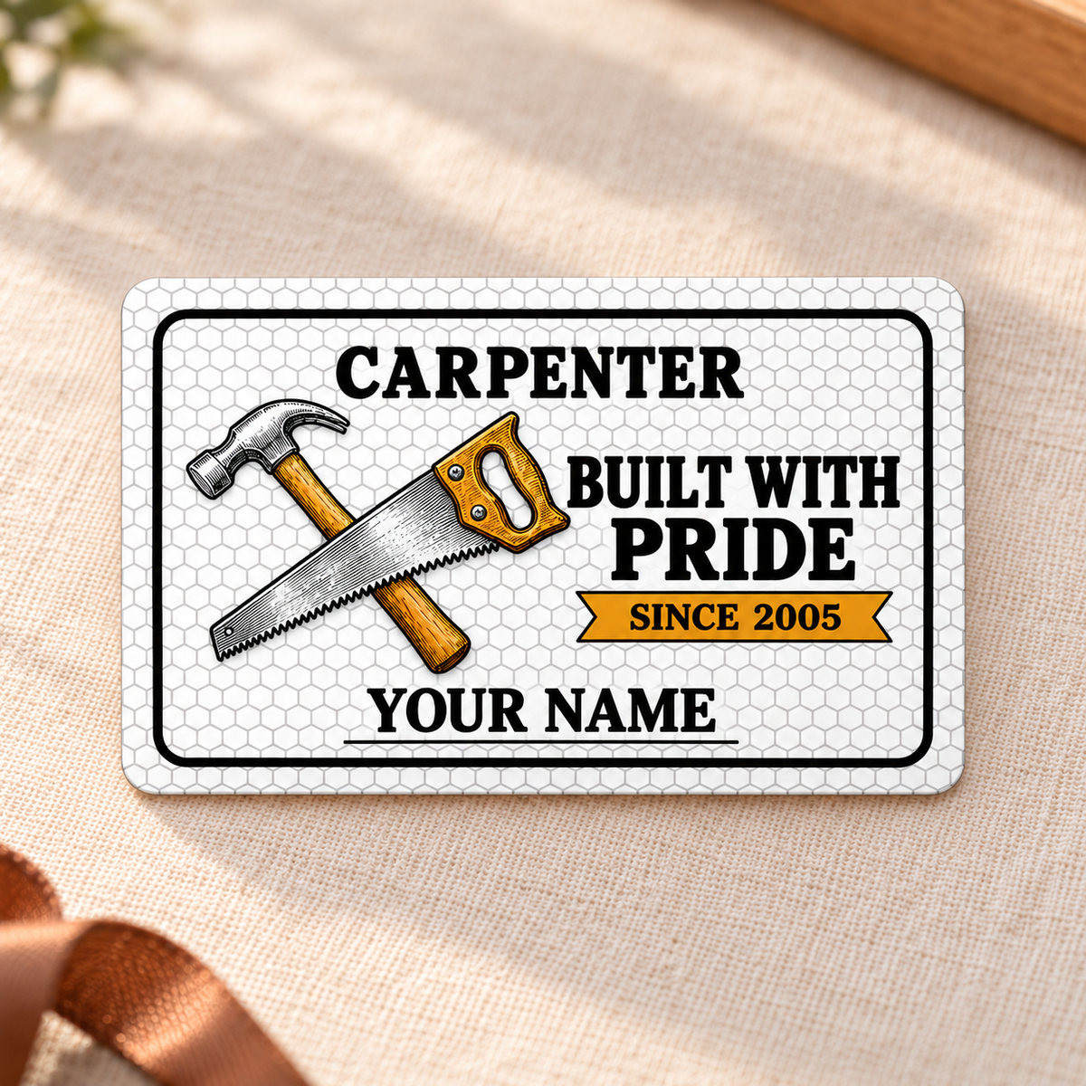 Front of the Carpenter Honeycomb Craft aluminum wallet card on cream linen.