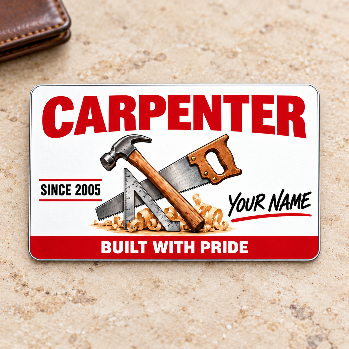 Front of the Carpenter Signature Classic aluminum wallet card on a pale warm stone surface.