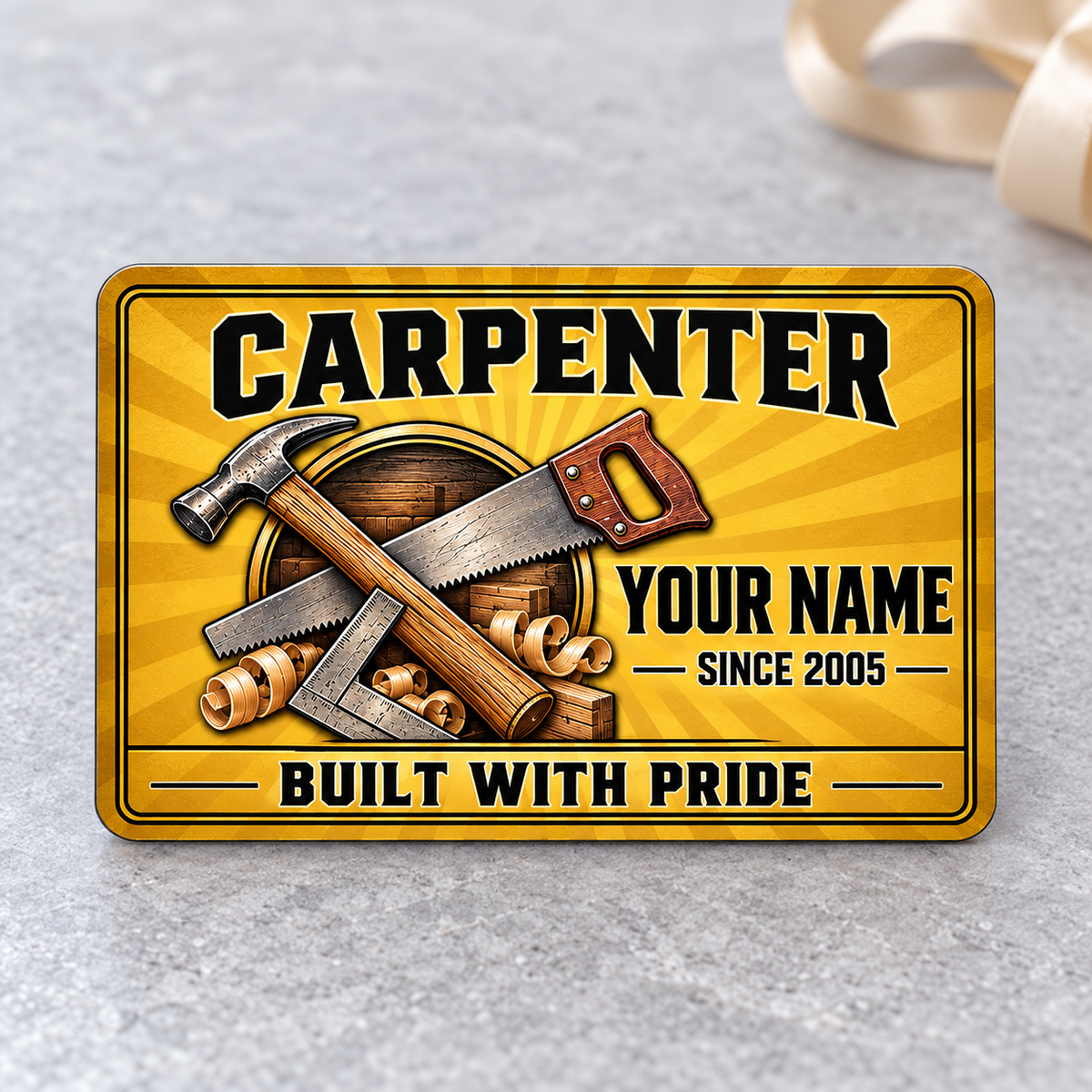 Front of the Carpenter Golden Milestone aluminum wallet card on pale gray stone.
