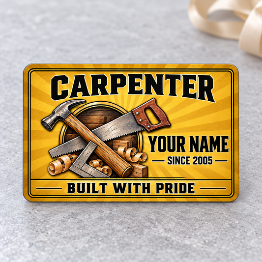 Front of the Carpenter Golden Milestone aluminum wallet card on pale gray stone.