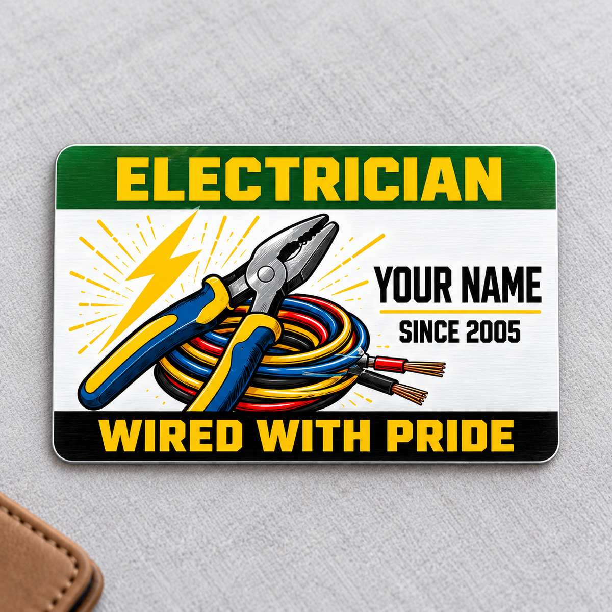 Electrician Green Band aluminum wallet card, front view on light gray fabric