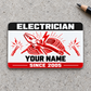 Electrician Red Monochrome aluminum wallet card, front view on light gray concrete