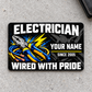 Electrician Midnight Pride aluminum wallet card, front view on light concrete