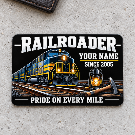 Railroader Midnight Pride aluminum wallet card front, centered on pale gray concrete.