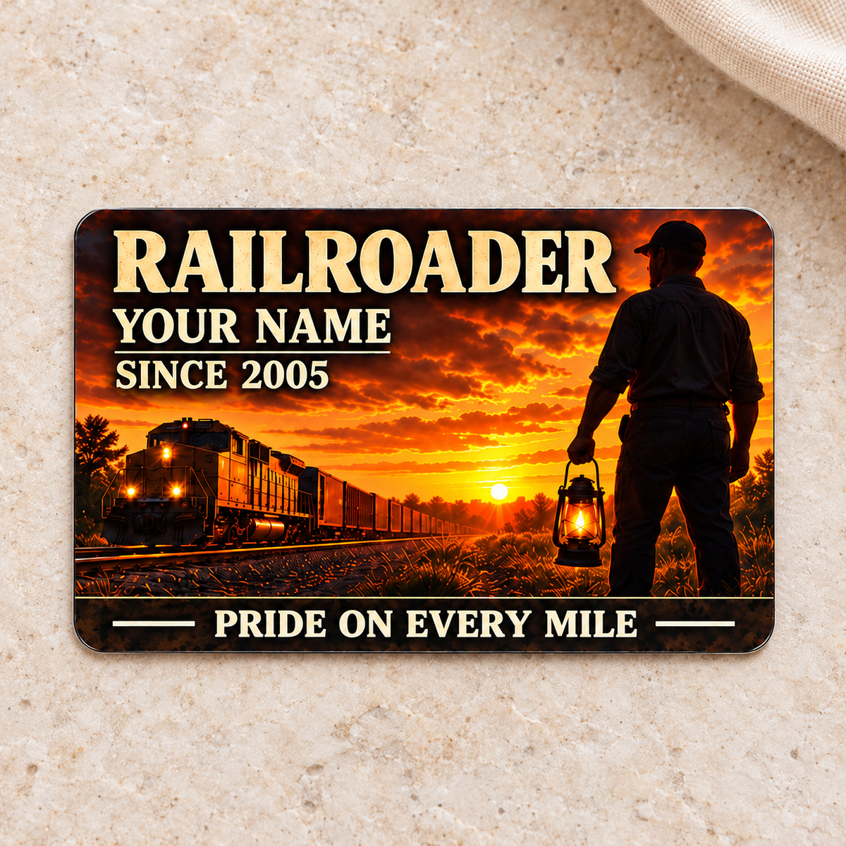Railroader Sunset Workday aluminum wallet card front centered on light warm stone.