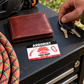 Arborist wallet card in an arborist tree-care rest area with an adult man and leather wallet.