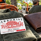 Arborist wallet card in a arborist tree-care rest area with an adult man and leather wallet.