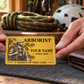 Arborist wallet card in a arborist tree-care rest area with an adult man and leather wallet.