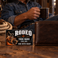 Bull Riding/Rodeo Midnight Pride aluminum wallet card beside a closed brown wallet during a tack-room coffee break