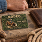 Bull Riding/Rodeo Rugged Field wallet card on worn canvas beside a brown wallet, leather glove and coiled rope