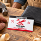 The printed front of the Carpenter Red Monochrome Craft aluminum wallet card shown in an occupational lifestyle setting with an adult worker.