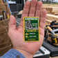 The printed front of the Carpenter Trade Legend Collectible aluminum wallet card shown in an occupational lifestyle setting with an adult worker.