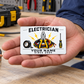 Electrician Minimal Tool Grid wallet card resting on an adult palm at an orderly workbench